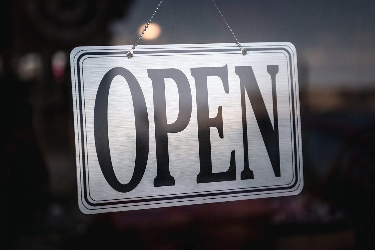 An OPEN sign in a small-business window